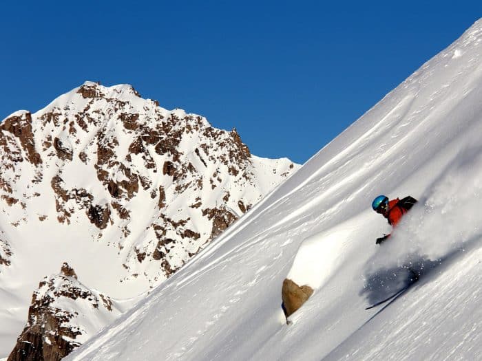 A snow-covered rocky mountainside of the Tordrillo Mountains in Alaska.