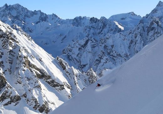 Heli skiing excursion on a snow-covered mountain side in Alaska.