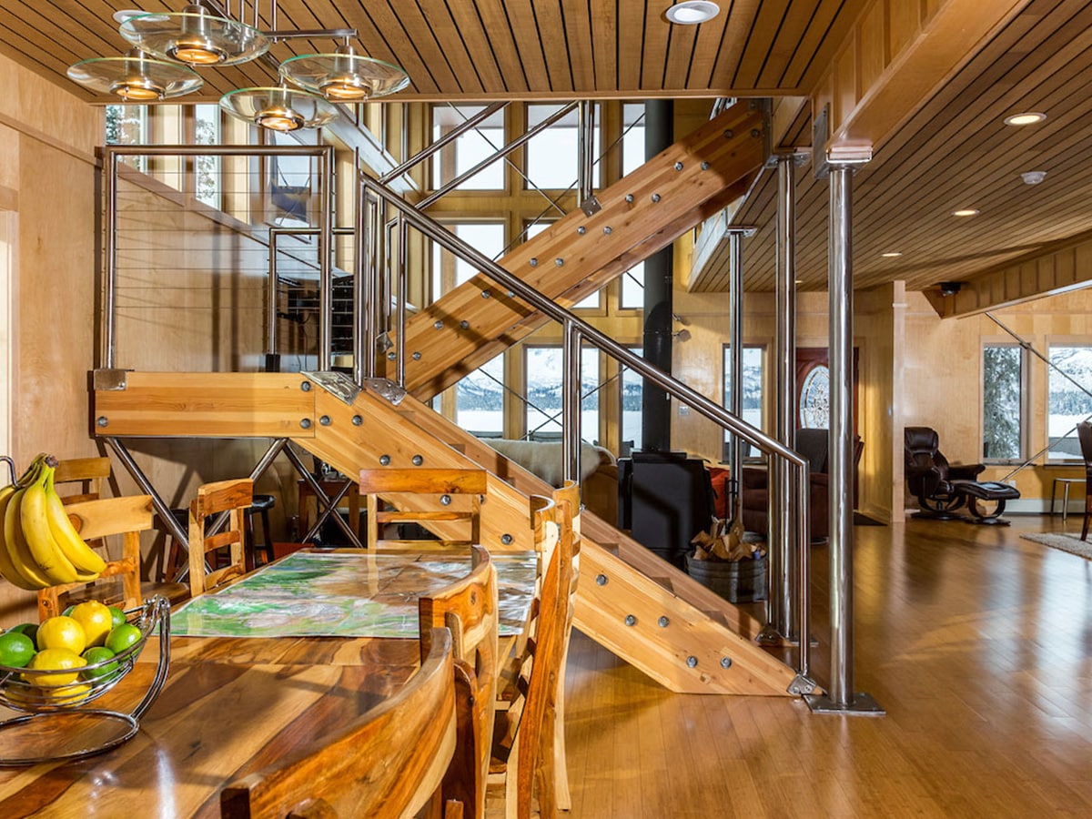 Judd Lake Lodge dining room table with a view of the stairs that brings guests to the second floor.