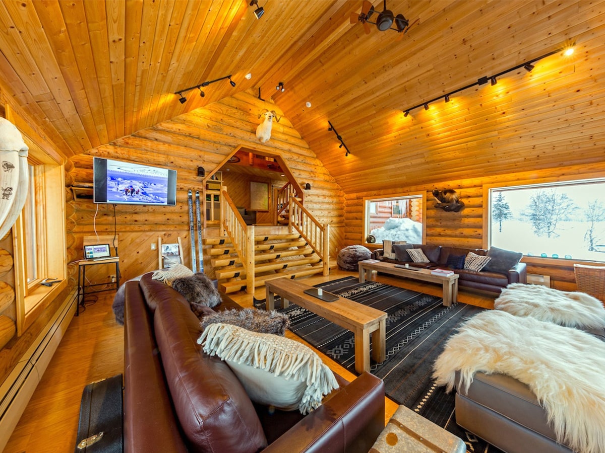 An inside view of the Tordrillo Mountain Main Lodge living room area on a winter day.