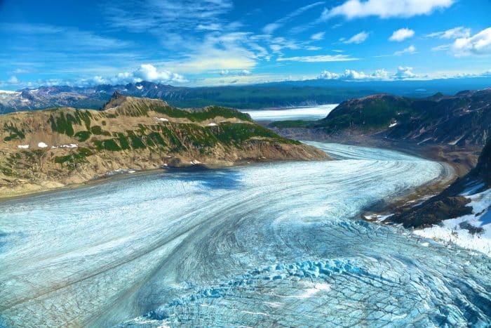 Birds eye view of a large glacier on a summer day in the Tordrillo Mountains.