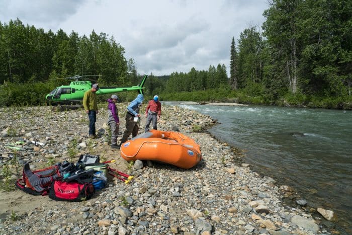 A group of guests from Tordrillo Mountain Lodge get dropped off by helicopter for a day of Alaska rafting.