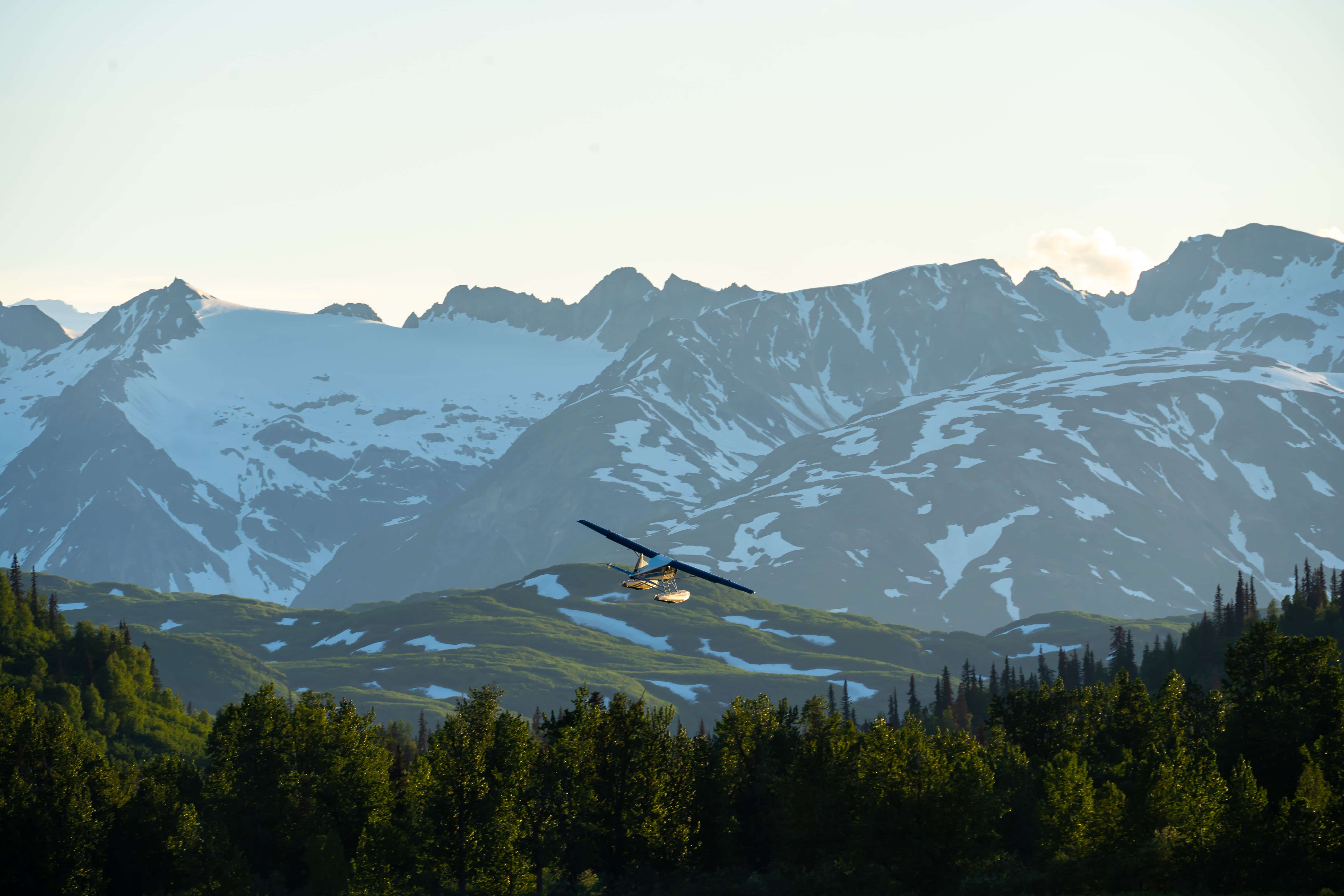 bush plane flying through the tordrillo mountains