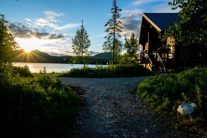 tordrillo mountain lodge sitting on judd lake at sunset in the summer