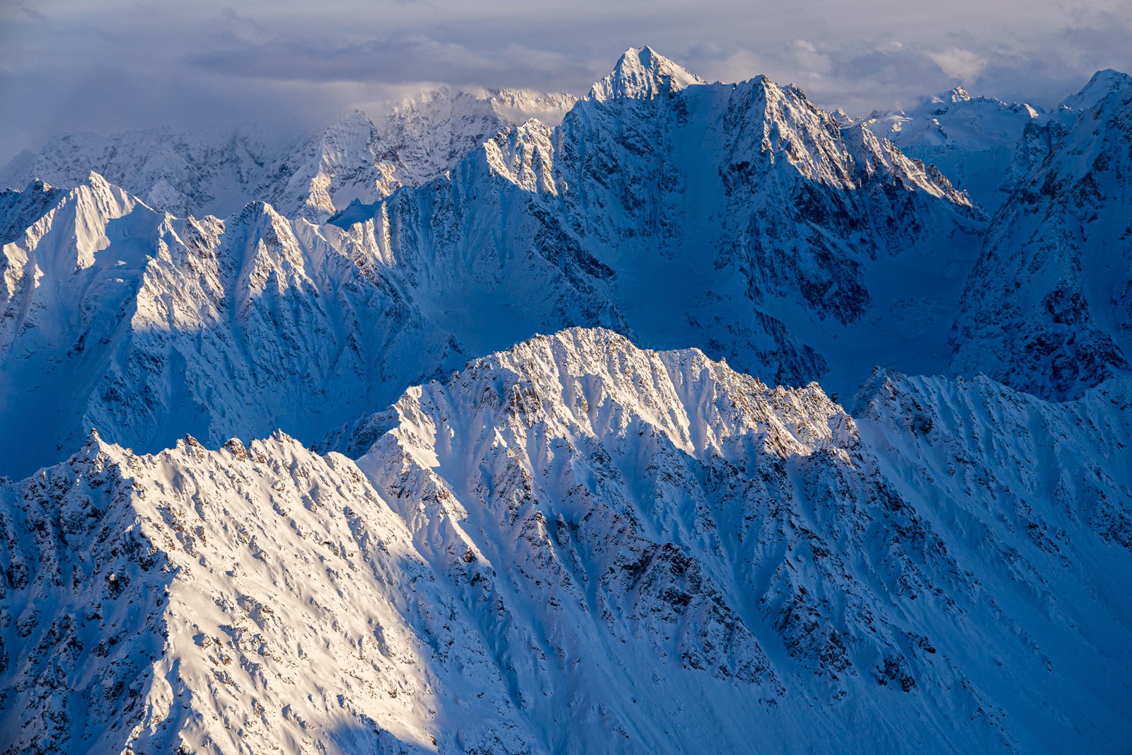 flying through the tordrillo mountains in the winter