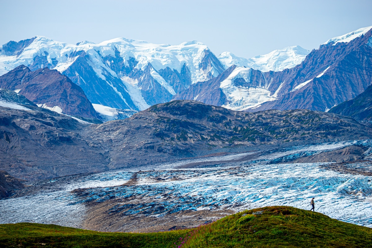 a man hiking along the trimble glacier in the tordrillo mountains
