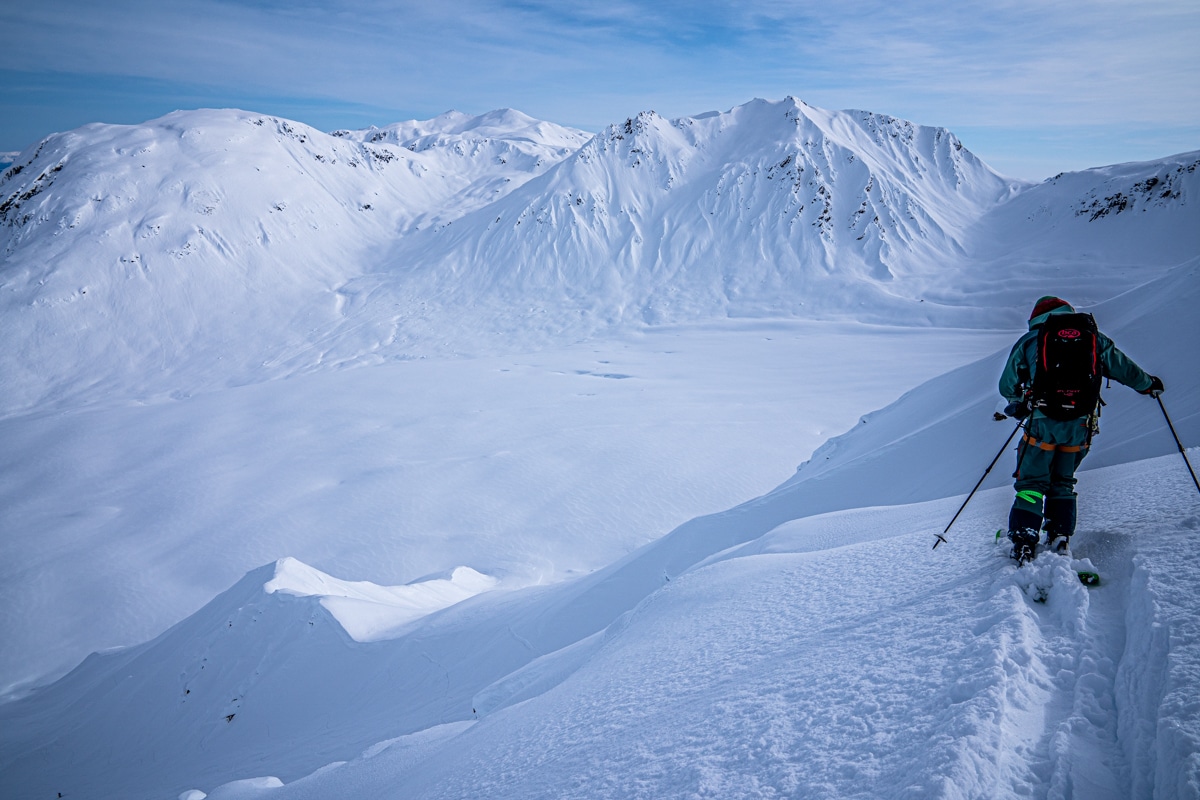 Cross country skier moves through a fresh layer of snow in the Alaskan mountains.