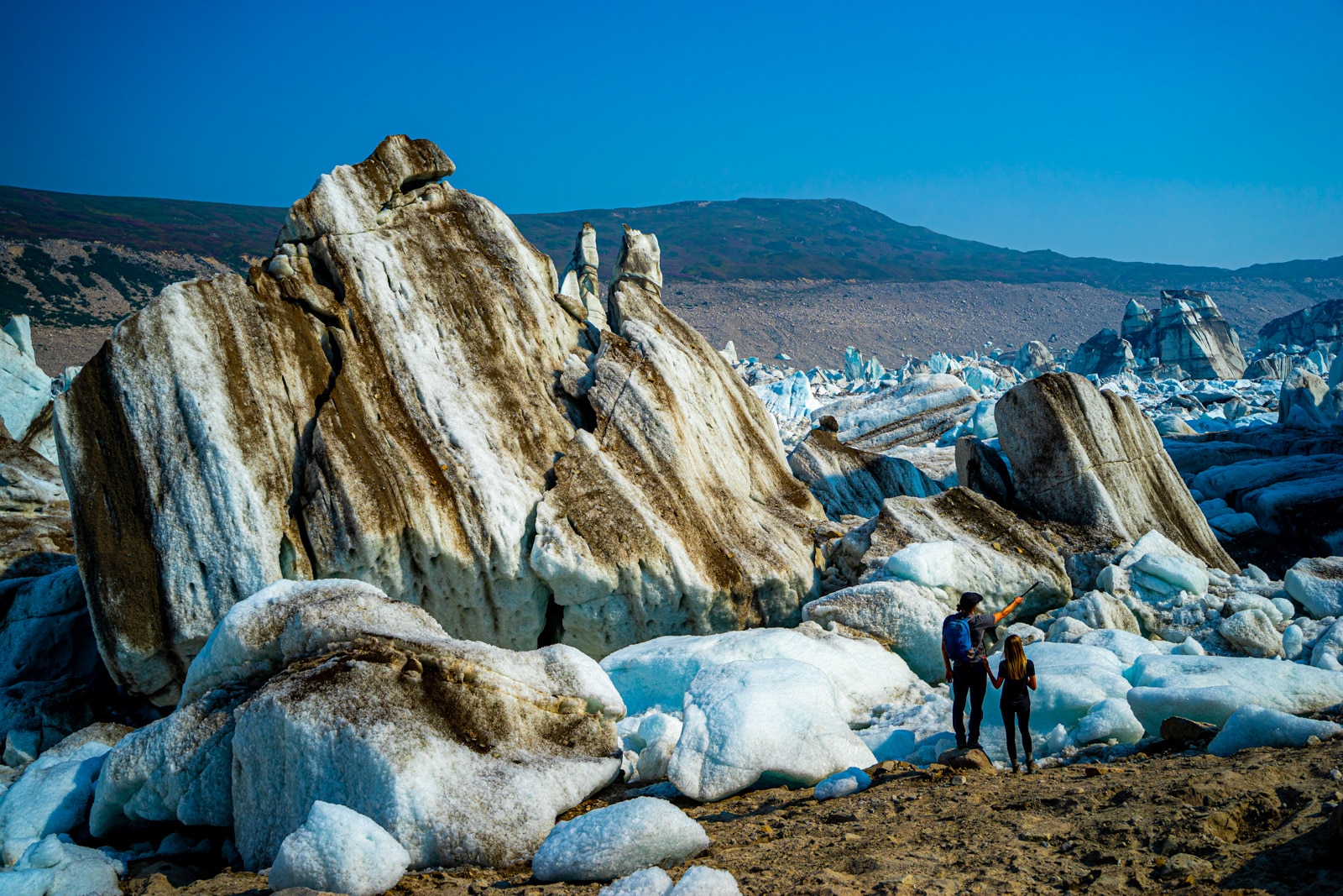 a couple explores icebergs in the tordrillo mountains