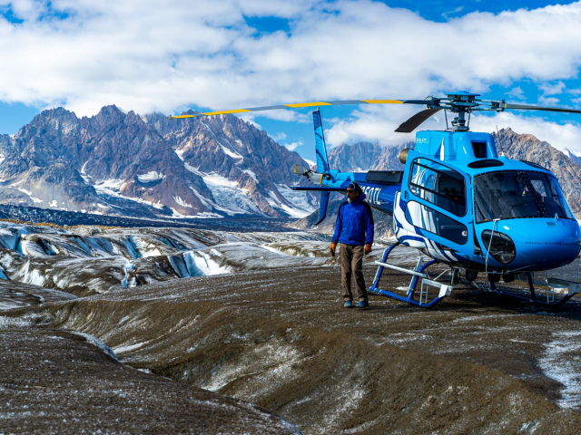 a man out exploring a glacier by helicopter in the tordrillo mountains