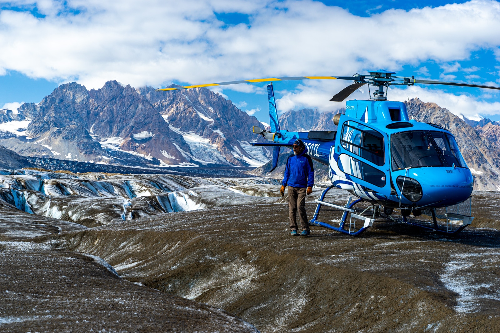 a man out exploring a glacier by helicopter in the tordrillo mountains