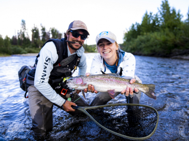 two people holding a rainbow trout on the talchalitna river