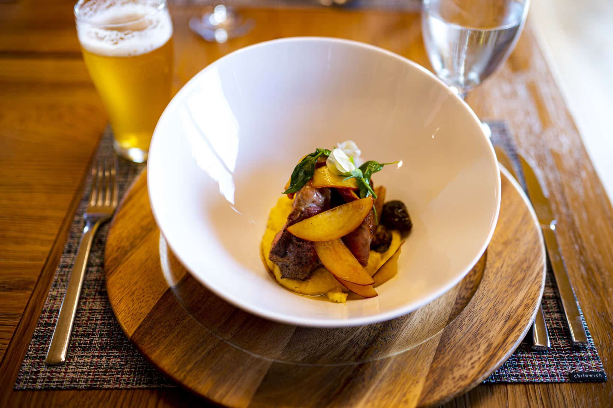 pheasant dinner plated with a beer at tordrillo mountain lodge