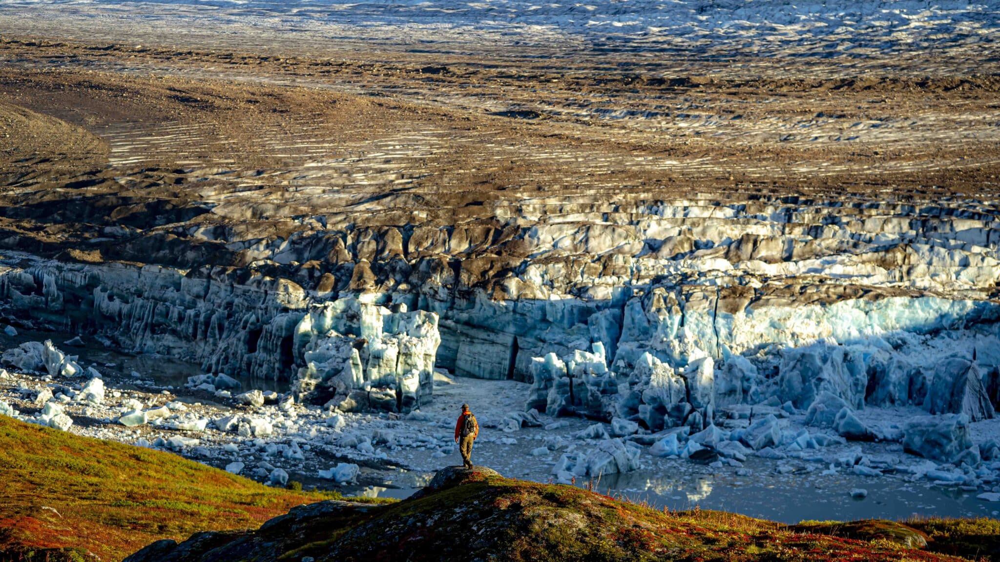 a man hiking above the triumvirate glacier in the tordrillo mountains