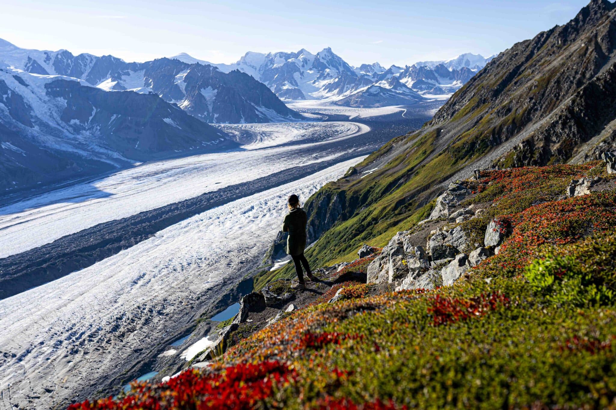 a woman overlooks the capps glacier in the tordrillo mountains