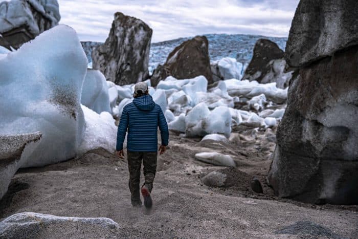 a man walks through an ice field in the tordrillo mountains